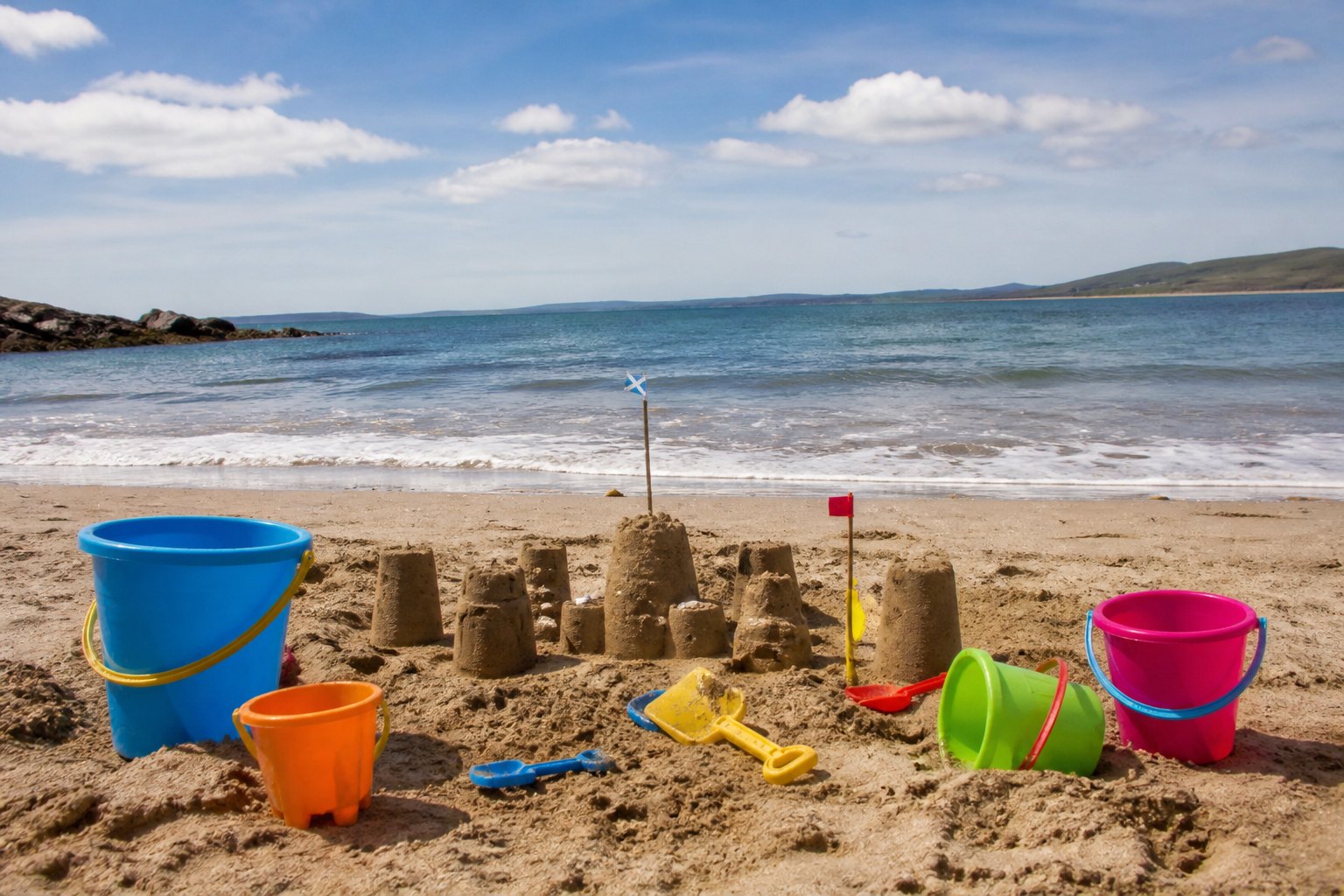 Buckets, spades and a sandcastle on a holiday club beach day