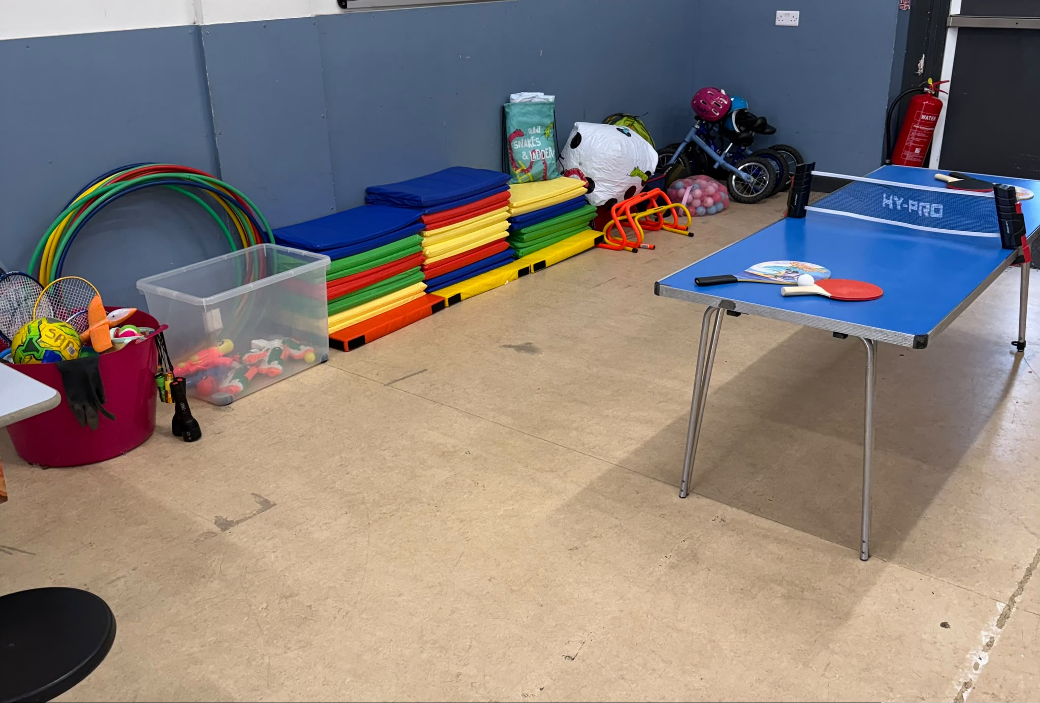 Table tennis, mats and sports kit in the hall