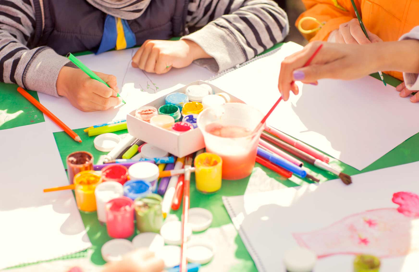 Children painting and drawing together at Danni's